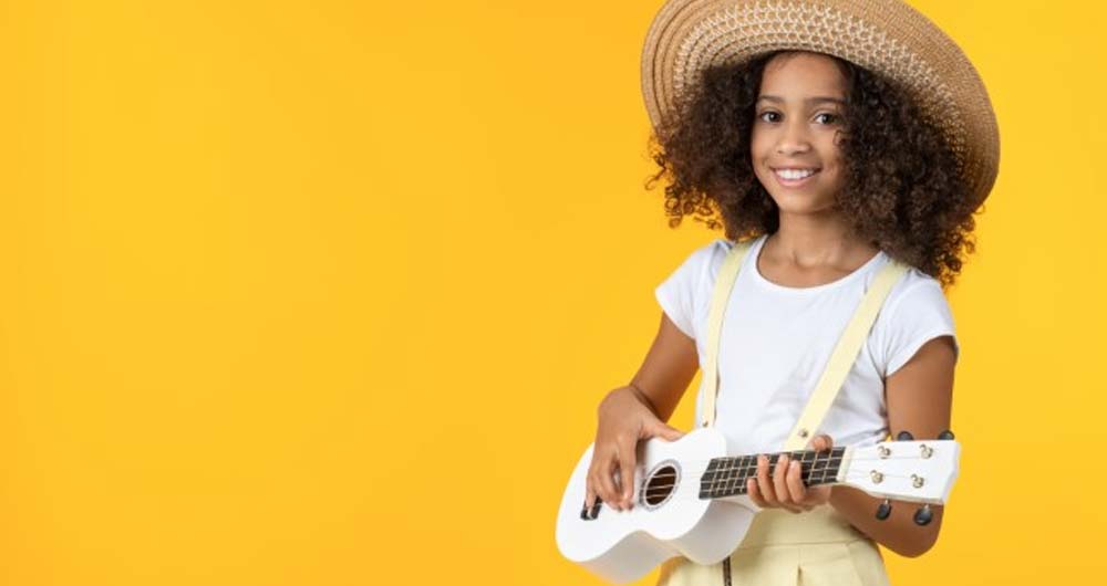 girl with big hat and small guitar